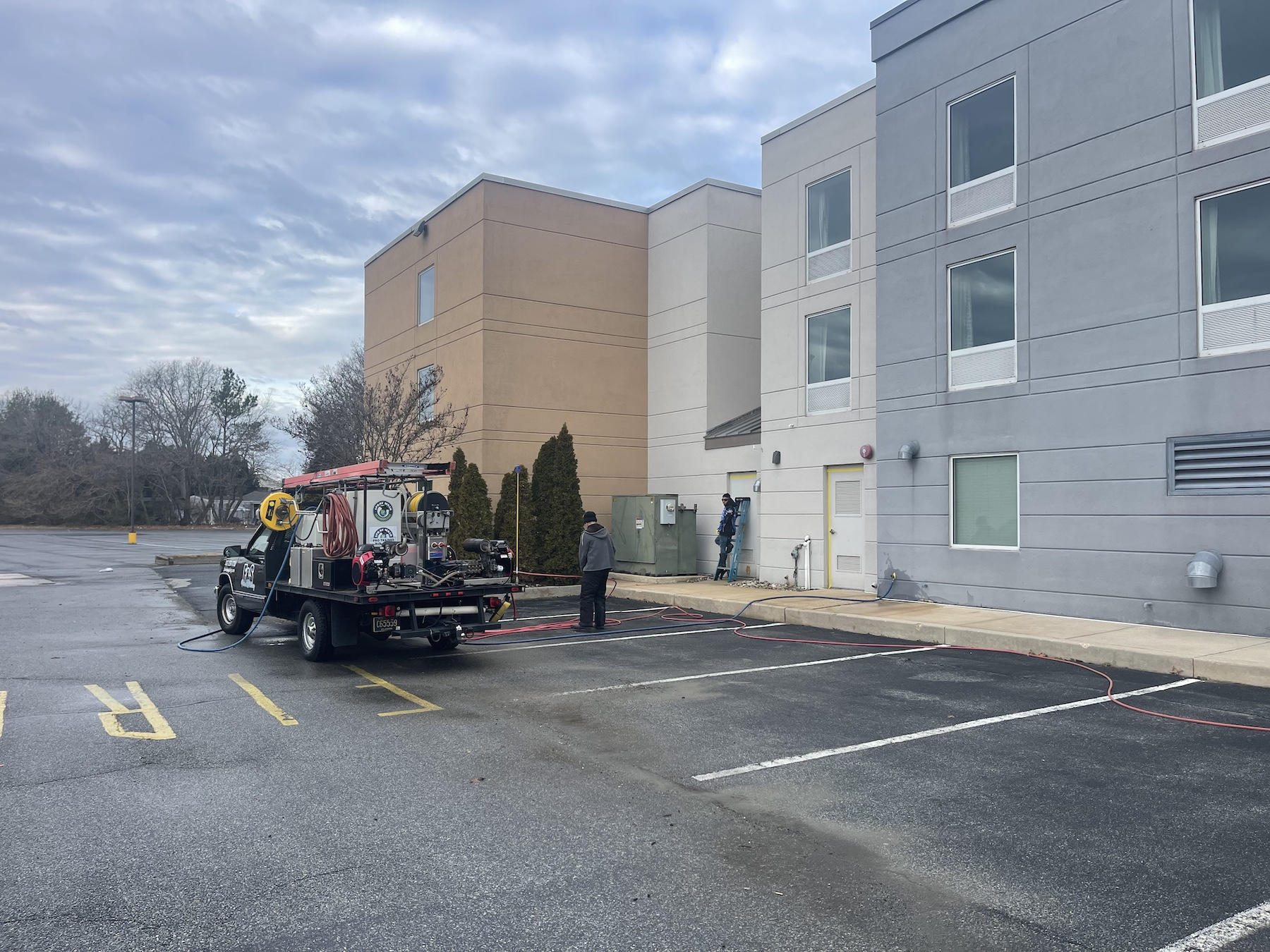 ad13fbfd-b32e-4862-8988-67d1fc3f0963.jpeg - F&S Power Washing Commercial Property Manager Supervising Pressure Washing Services on a Business Exterior